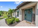 Close up of the front door and landscaping at 6250 Grandview Hill Ct, Bradenton, FL 34203