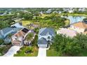 An aerial perspective of home near the lake and lush greenery in the community at 6307 Laurel Creek Trl, Ellenton, FL 34222