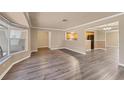 Bright living room featuring wood floors, a bay window, and views into the kitchen and dining area at 6760 14Th S St, St Petersburg, FL 33705