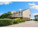 Beautifully landscaped two-story home with a neutral color scheme and elevated design at 76 Tidy Island Blvd, Bradenton, FL 34210