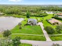 Expansive aerial view of a home situated on a large lot with a lake at 7832 Panther Ridge Trl, Bradenton, FL 34202
