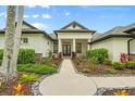 Up-close view of the home's entrance, highlighting the walkway and the carefully arranged landscaping at 7832 Panther Ridge Trl, Bradenton, FL 34202