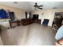 Spacious living room with tile flooring, ceiling fan, and ample space for furniture at 815 12Th W Ave, Bradenton, FL 34205