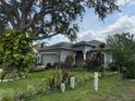 Charming single-story home with lush landscaping and well manicured lawn at 817 Tallgrass Ln, Bradenton, FL 34212