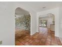 Open-concept hallway with stone accent wall leading to the outdoor pool area at 8255 Longbay Blvd, Sarasota, FL 34243