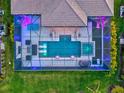 Aerial perspective of a luxurious pool and spa area enclosed within a screened lanai at 8272 Redonda Loop, Bradenton, FL 34202