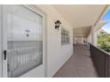 Condo entryway featuring a secure door, hallway, and decorative lighting at 860 Virginia St # 304, Dunedin, FL 34698