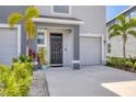 View of the front entrance of the townhome showing the well-maintained landscaping at 8628 Milestone Dr, Sarasota, FL 34238
