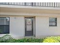 Image of the front door with surrounding green bushes and plants at 1001 Benjamin Franklin Dr # 106, Sarasota, FL 34236