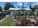 Charming single-story home with a metal roof, complemented by a landscaped front yard at 1113 23Rd W Ave, Bradenton, FL 34205