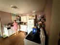 A kitchen with white cabinets, appliances, and a functional layout at 1113 23Rd W Ave, Bradenton, FL 34205