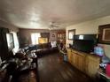 Cozy living room featuring hardwood floors, a ceiling fan, and comfortable leather furniture at 1113 23Rd W Ave, Bradenton, FL 34205
