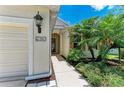 Close-up view of home exterior showing address number, front door, and manicured landscaping at 11811 Fennemore Way, Parrish, FL 34219