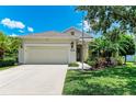 Inviting one-story home featuring a two-car garage, landscaped front yard, and neutral exterior paint at 11811 Fennemore Way, Parrish, FL 34219