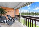 Inviting patio with cushioned chairs offers serene water views and a relaxing outdoor space at 1355 Rock Dove Ct # 1-2, Punta Gorda, FL 33950