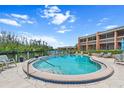 Community pool boasts waterfront views, poolside seating, and a refreshing escape at 1355 Rock Dove Ct # 1-2, Punta Gorda, FL 33950