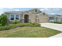 Charming single-story home with a two-car garage and stone accents, with beautiful landscaping at 17536 Cantarina Cv, Bradenton, FL 34211
