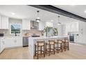 Modern kitchen featuring an island, stainless steel appliances, pendant lighting and white cabinetry at 1801 W Saint Isabel St, Tampa, FL 33607