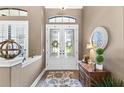 Inviting foyer with decorative double doors, a stylish rug, and elegant decor at 2152 Majestic Oaks Blvd, Clearwater, FL 33759