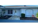 Exterior view of the front entrance with tiled walkway and well maintained landscaping at 2178 Calcutta Rd, Punta Gorda, FL 33983