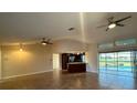 Open-concept living room featuring tile flooring, ceiling fans, and access to the lanai at 2178 Calcutta Rd, Punta Gorda, FL 33983