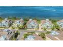 A birds eye view shows the community of waterfront homes with a tranquil bay in the background at 276 Saint Lucia Dr # 101, Bradenton, FL 34209