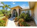 Inviting front walkway leading to an arched, screened entryway with lush landscaping at 2801 Dalhart Ave, North Port, FL 34286