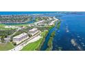 Scenic aerial view of waterfront property and golf course with the condo complex circled in white at 3070 Grand Bay Blvd # 644, Longboat Key, FL 34228