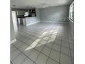 Bright open-concept living room featuring neutral walls and large tile flooring at 3231 Cambridge Dr, Sarasota, FL 34232