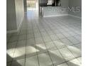 Bright open-concept living room featuring neutral walls and large tile flooring at 3231 Cambridge Dr, Sarasota, FL 34232