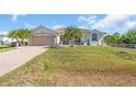 Inviting single-story home with well-manicured lawn, tile roof and attached two-car garage at 3620 Como St, Port Charlotte, FL 33948