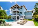 Inviting backyard features a refreshing pool, patio seating, and stylish landscaping at 3702 5Th Ave, Holmes Beach, FL 34217