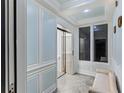 Interior hallway featuring an elevator, custom millwork, and tiled flooring at 3800 Gulf Blvd # Ph, St Petersburg, FL 33706