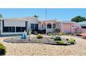Well-maintained single-story home with a decorative front yard and vibrant landscaping at 409 Bryn Mawr Is, Bradenton, FL 34207