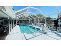 Screened-in pool area with lounge seating, perfect for outdoor relaxation and entertainment at 409 Bryn Mawr Is, Bradenton, FL 34207