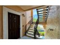 Condo entrance featuring a private stairway and a sturdy, secure front door with a peep-hole at 4142 Central Sarasota Pkwy # 1423, Sarasota, FL 34238