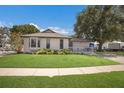 Beautiful single-story house with a well-kept lawn, bright exterior paint, and a welcoming front porch area at 5403 2Nd W Ave, Bradenton, FL 34209