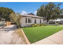 Inviting single-story home with a bay window, lush lawn, and a charming front porch, perfect for relaxing outdoors at 5403 2Nd W Ave, Bradenton, FL 34209