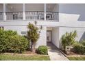 Exterior of the building showcasing well-maintained landscaping and inviting entryway at 5623 Midnight Pass Rd # 615, Sarasota, FL 34242