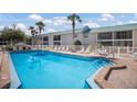 Resort style pool deck with lounge chairs surrounding the beautiful in-ground pool at 5623 Midnight Pass Rd # 615, Sarasota, FL 34242