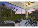 Relaxing screened lanai with serene views of the backyard, landscaping, and water at 5816 Mezzana Run, Palmetto, FL 34221