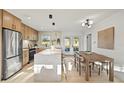 Modern kitchen with stainless steel appliances, a large island, and an adjacent dining area perfect for Gathering meals at 5900 6Th S Way, St Petersburg, FL 33705