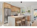 Stylish kitchen island with seating, modern appliances, ample counter space, and contemporary cabinetry at 5900 6Th S Way, St Petersburg, FL 33705