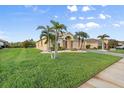 A home with large front yard, decorative rock and grass with palm trees at 5902 106Th E Ter, Parrish, FL 34219