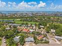 Panoramic aerial view showcases the property's prime location near lush golf course and stunning water views at 5916 Gulfport S Blvd, Gulfport, FL 33707