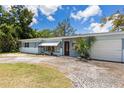 Charming single-story home with a light blue exterior, well-maintained lawn, and inviting curb appeal at 5916 Gulfport S Blvd, Gulfport, FL 33707