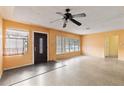 Inviting living room featuring neutral walls, Terrazzo flooring, and a ceiling fan for added comfort at 5916 Gulfport S Blvd, Gulfport, FL 33707
