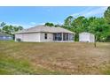 Exterior view of the screened lanai and shed in the backyard at 6104 Plamendon Ave, North Port, FL 34291