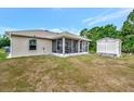 View of the screened lanai and the shed in the backyard at 6104 Plamendon Ave, North Port, FL 34291