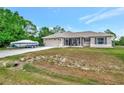 Single-story home featuring an attached two-car garage and a boat on the driveway at 6104 Plamendon Ave, North Port, FL 34291